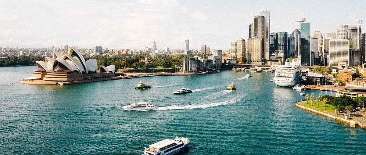 View of Sydney, Australia of the water, Sydney Opera House, and the Sydney skyline. Aldrich CPAs and Advisors offer International Business Services.