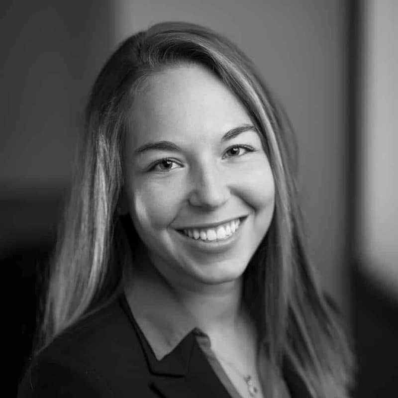 Jennifer Seifert's headshot in black and white in office space.