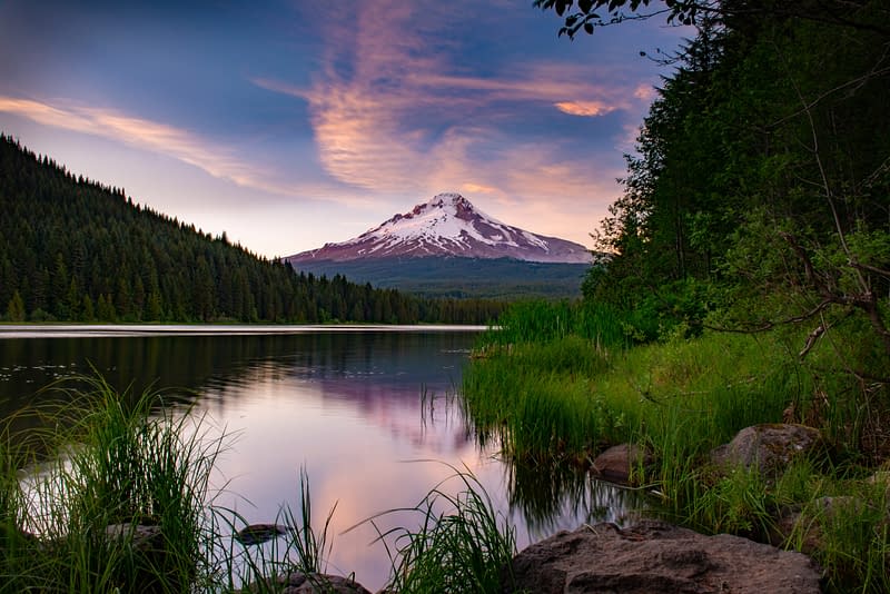 Mount Hood sunset over the water, with grass and trees surrounding the lake, in Oregon, where Casey McKillip, a 2026 NAPA Top Retirement Plan Advisors Under 40, and Aldrich Walth's Lead Retirement Plan Consultant is based out of.