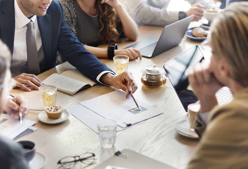 Sitting around a table planning for changes to corporate retirment plans due to the SECURE Act 2.0