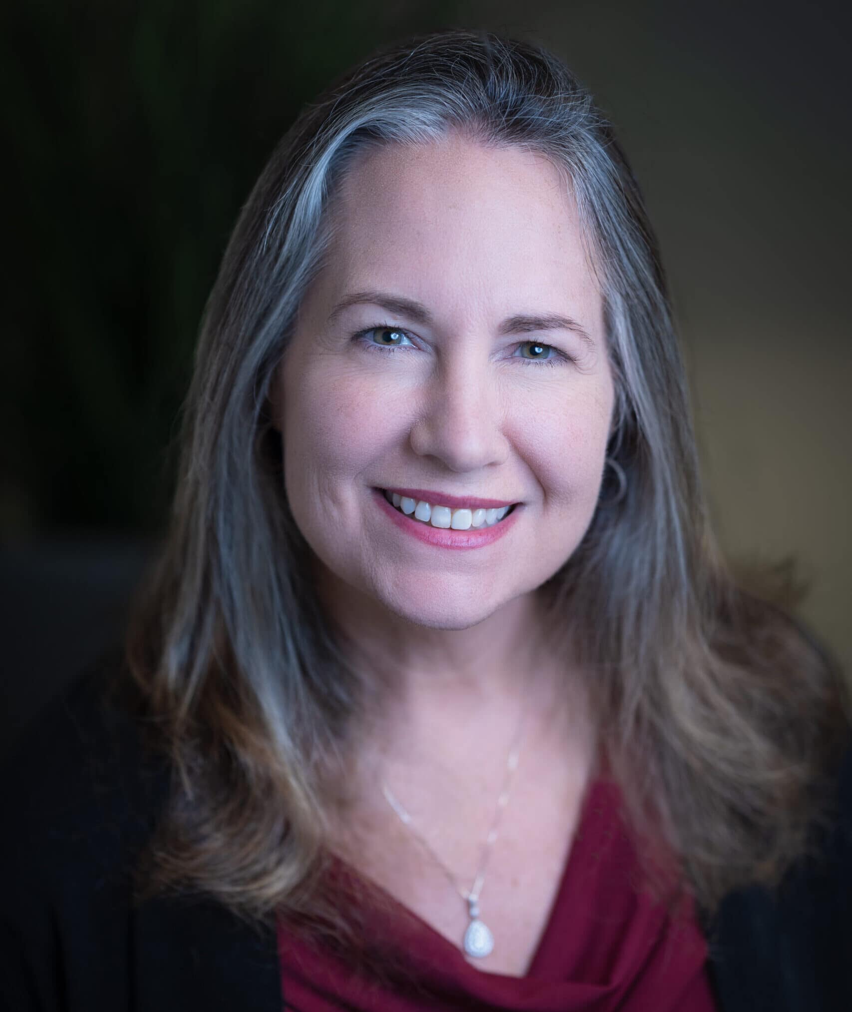 Diana Strassmaier's headshot in full color in office space.
