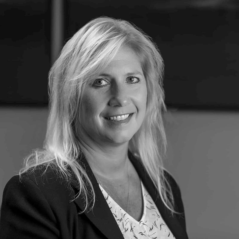 Kathy Hahn headshot in office space in black and white.