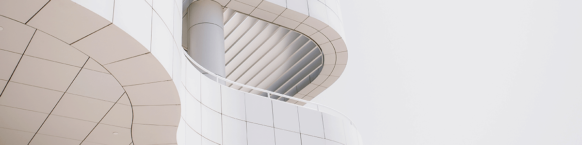 A "wave shaped" white tiled tall building with a balcony.