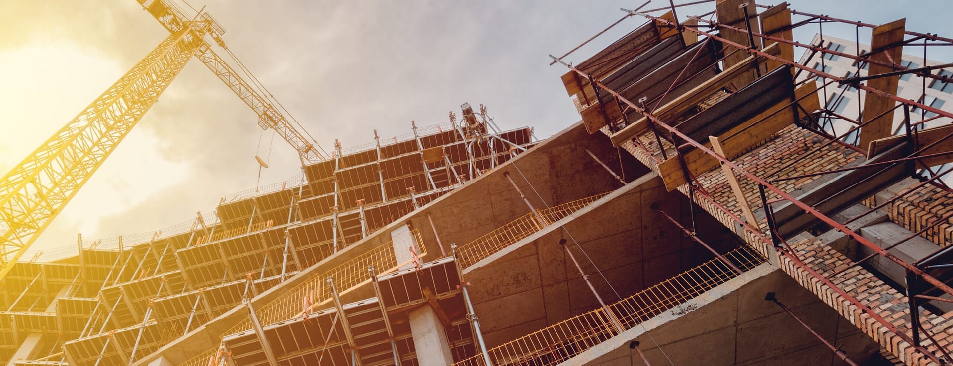 Building construction site with scaffolding, low angle view