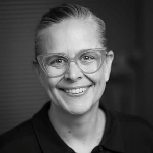 Carrie Sowder's headshot in black and white in office space.