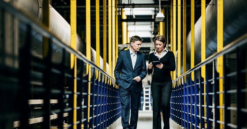 Two businesspeople. walking, inside environment