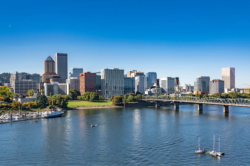 Down town landscape of modern Portland with high-rise glass and metal skyscrapers with offices and apartment buildings of various architecture and heights on the waterfront of the Willamette River