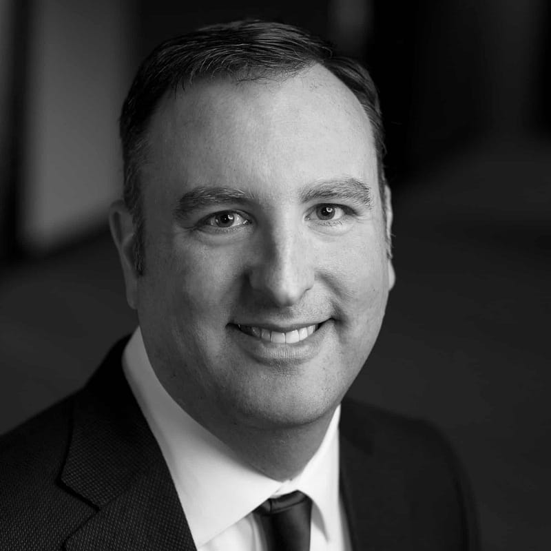 Ryan Northcutt's headshot in black and white in office space.