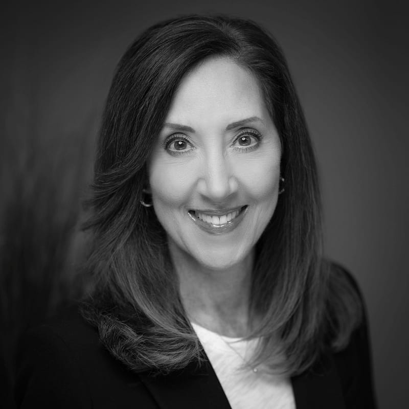 Kathy Peterson's headshot in black and white in office space.