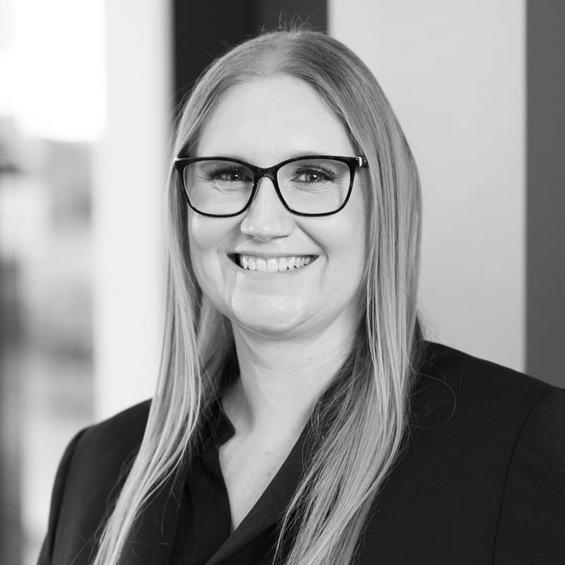 Lori Matyn's headshot in black and white in office space.
