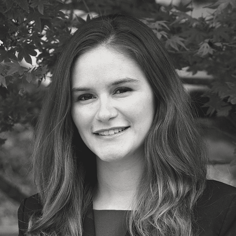 Melissa Gonzales' headshot in black and white in an outdoor space.