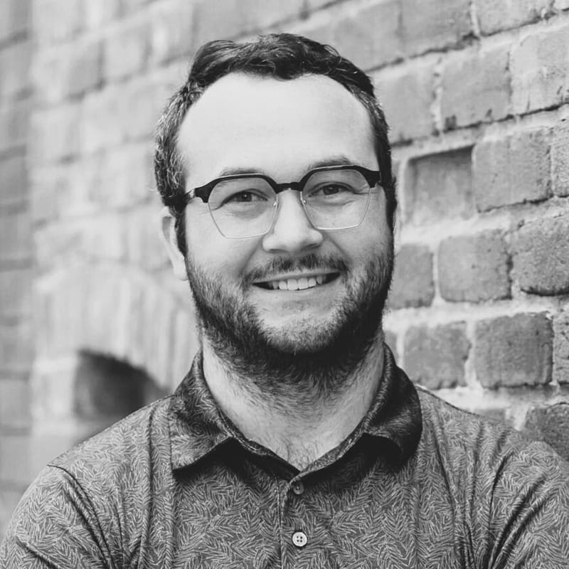 Colton Hanson's headshot in black and white in office space.