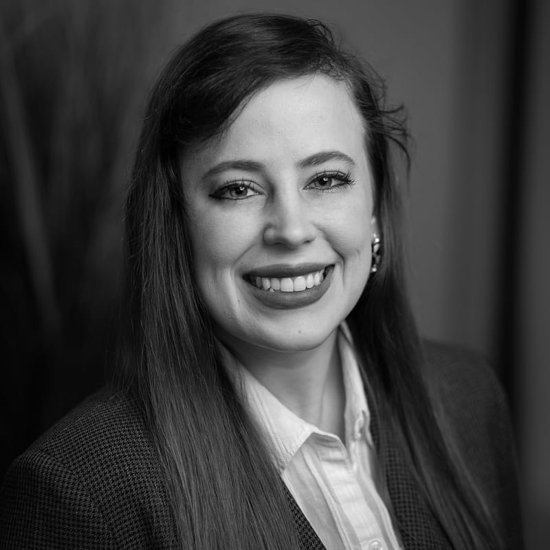 Xaviera Brady's headshot in black and white in office space.