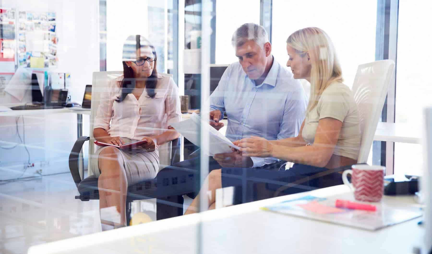 Two Aldrich consultants and a client sit and discuss succession planning services for an architecture or engineering firm.