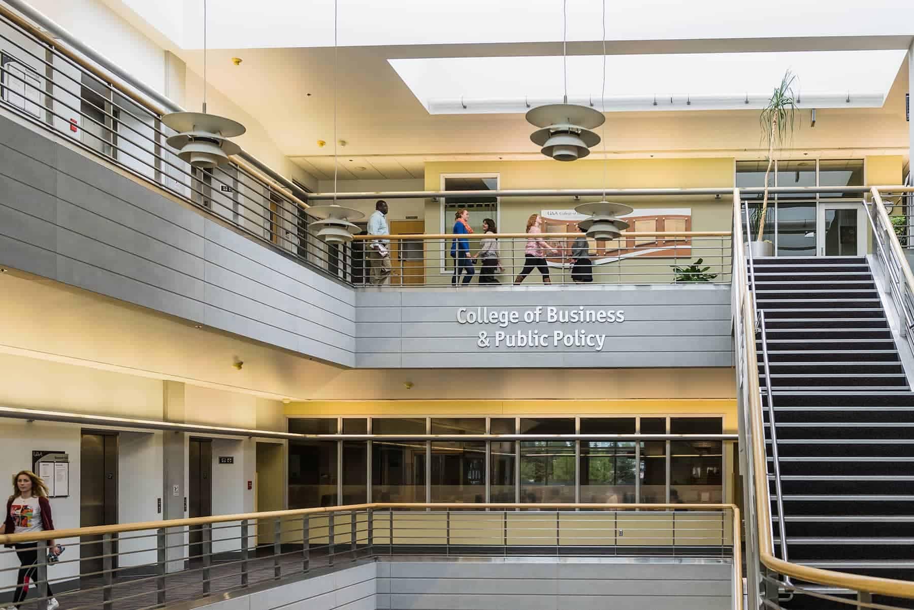 An image of a two storied balcony in a university building during the day.