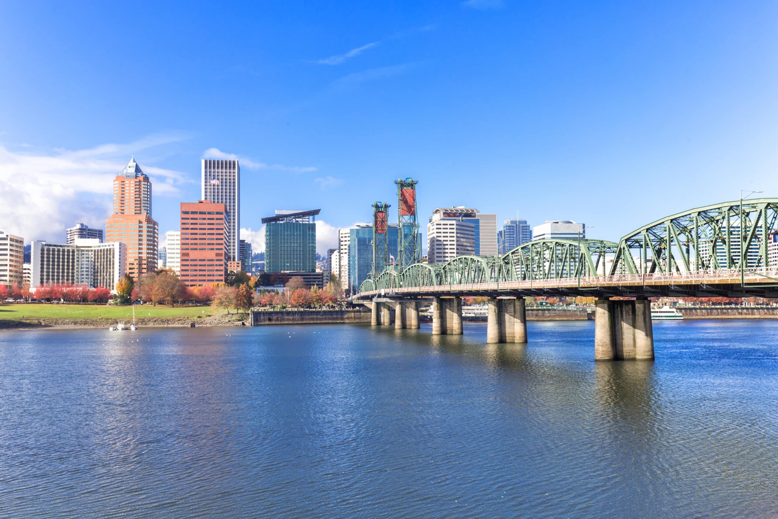 Steel Bridge over water with cityscape and skyline in Portland, OR.