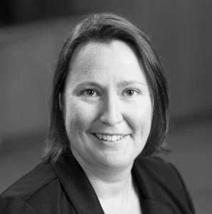 Christine Neuner's headshot in black and white in office space.