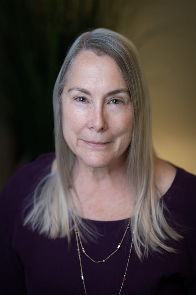 Carol Biederman's headshot in office space.