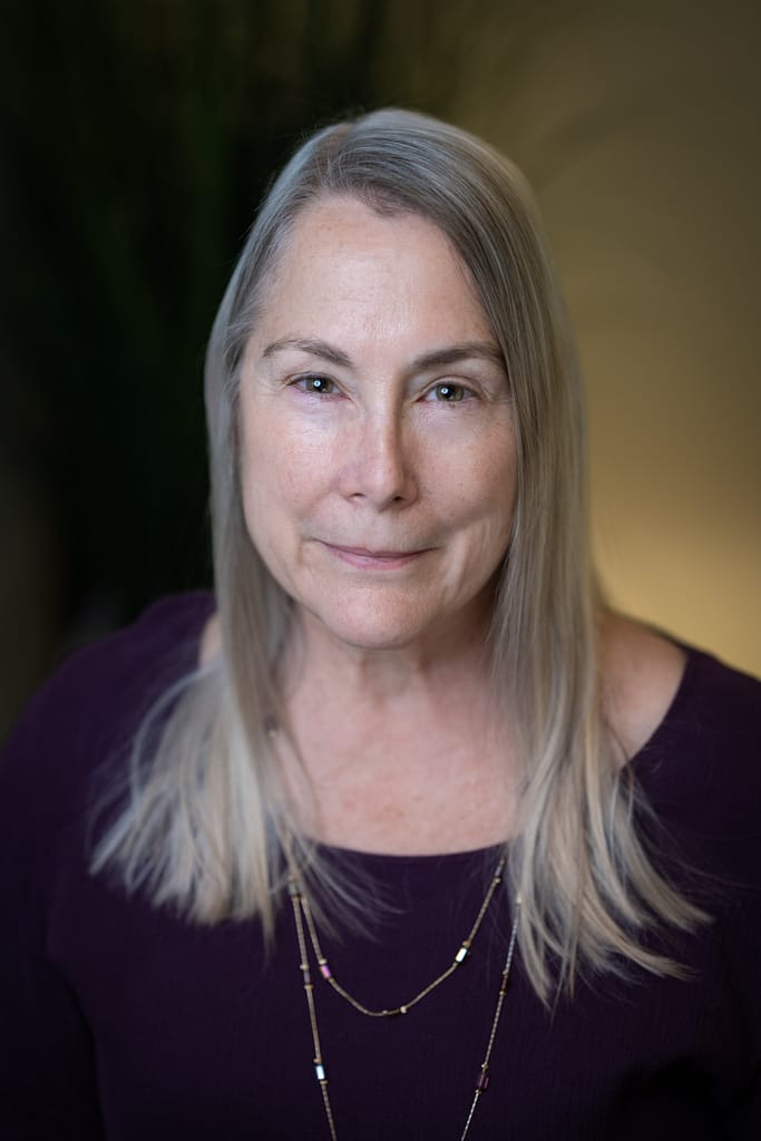 Carol Biederman's headshot in office space.
