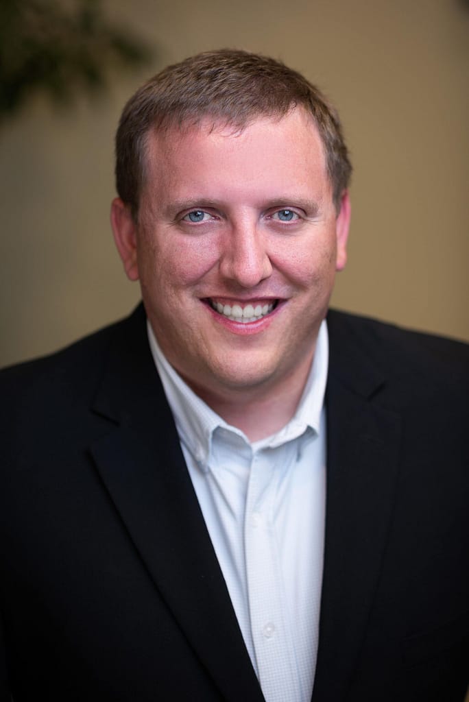 Jonathan McGuire's headshot in full color office space.