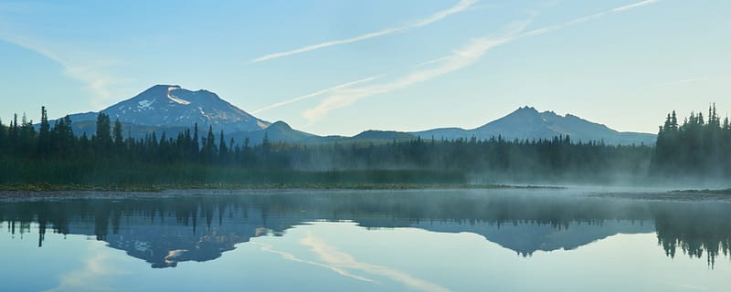 Fog over the Hosmer Lake in the morning with South Sister in central Oregon.