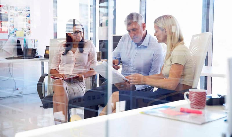 Two Aldrich consultants and a client sit and discuss succession planning services for an architecture or engineering firm.