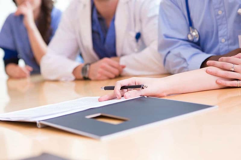 Physicians looking at medical documents.
