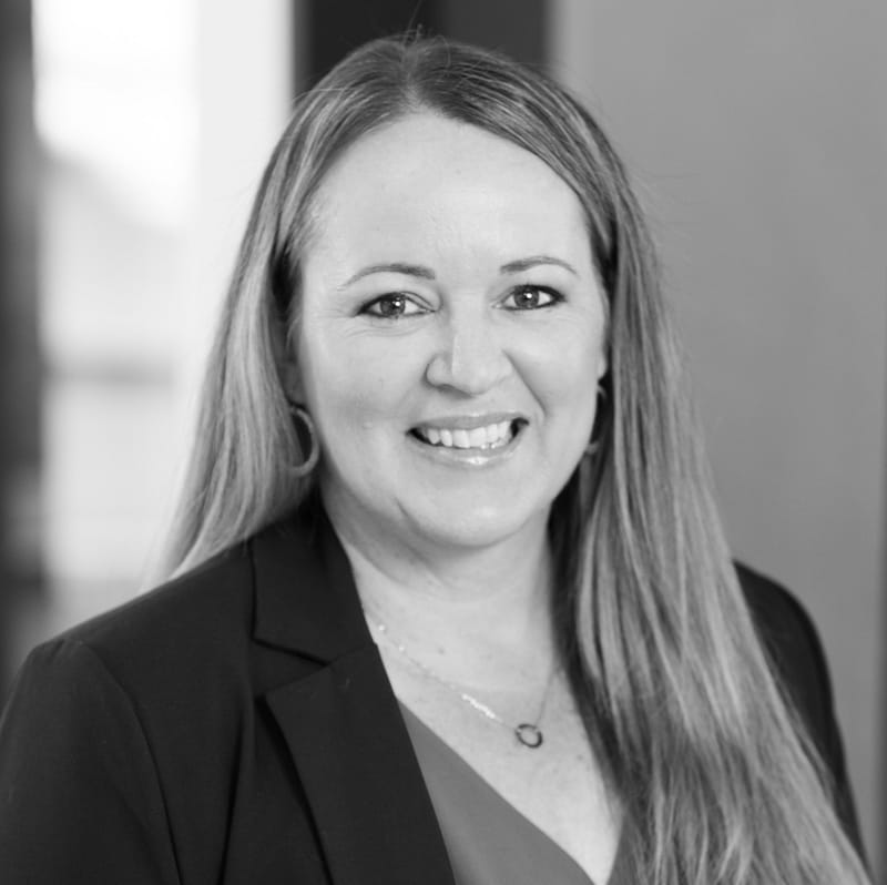 Karen DeBora's headshot in black and white in office space.