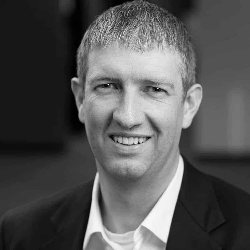 Seneca Steber's headshot in black and white in office space.