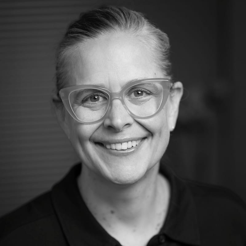 Carrie Sowder's headshot in black and white in office space.