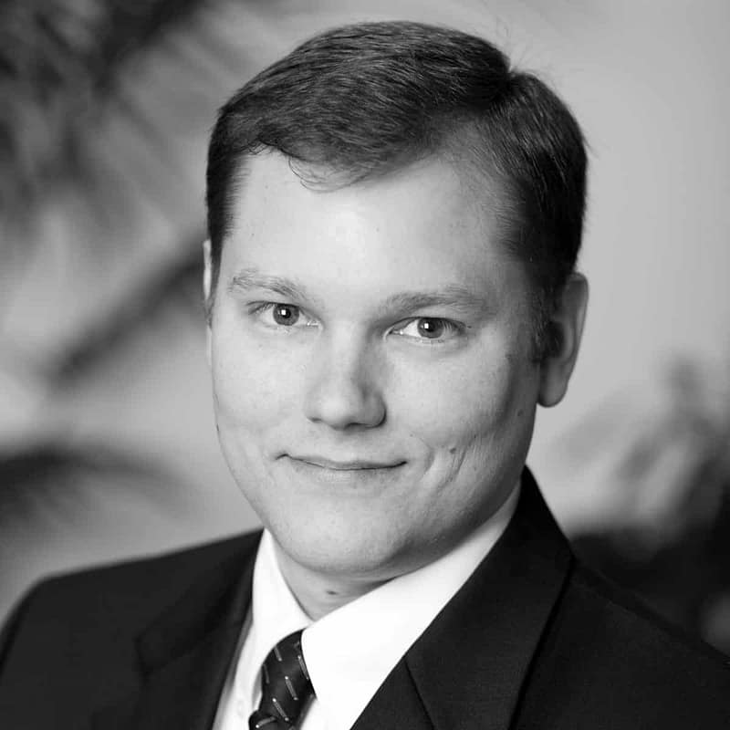 Philip D Meadows's headshot in black and white in office space.