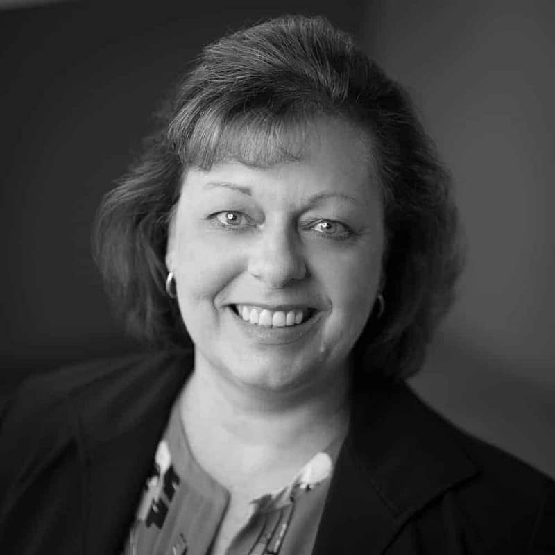 Cassie Smith's headshot in black and white in office space.