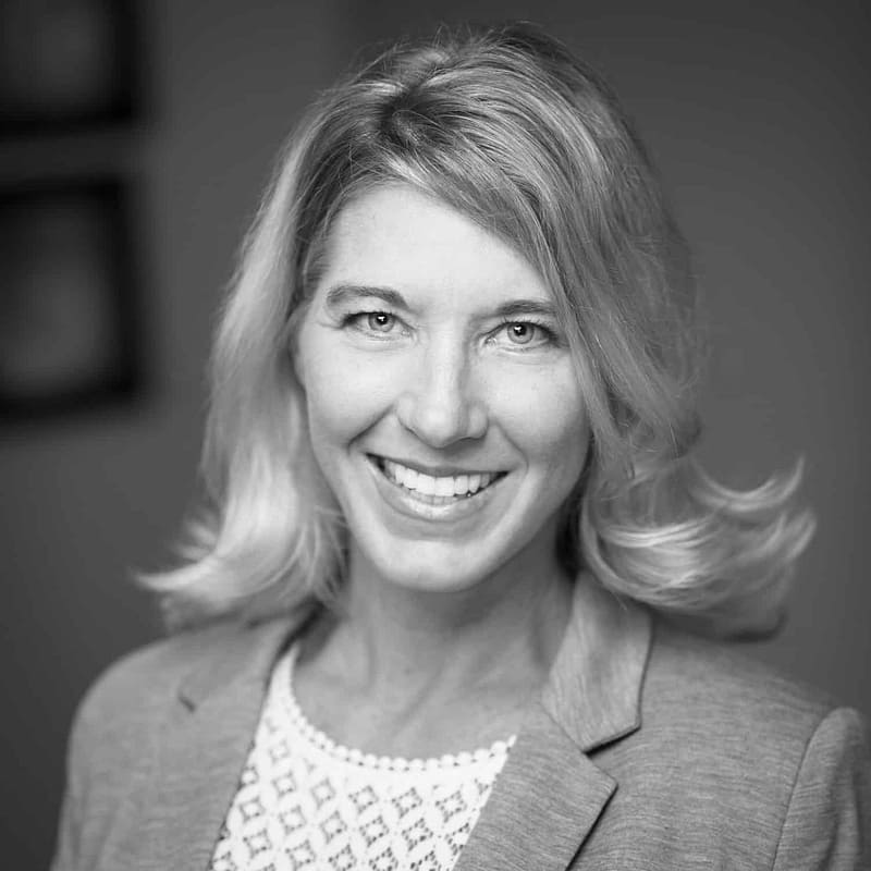 Debi Smith's headshot in black and white in office space.