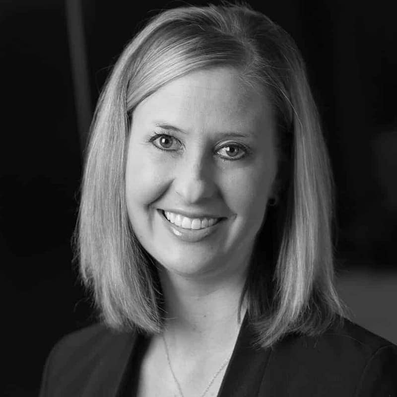 Lindsay Godfrey's headshot in black and white in office space.