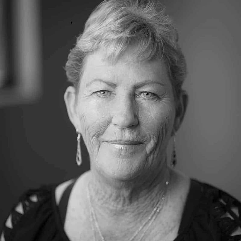 Patty Bee's headshot in black and white in office space.