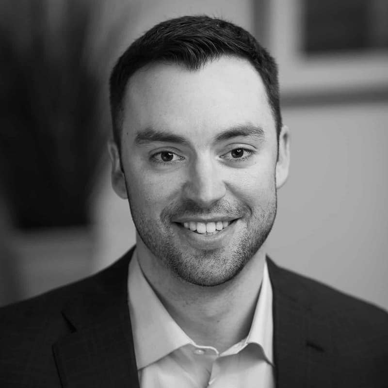 Brian Richardson's headshot in black and white in office space.