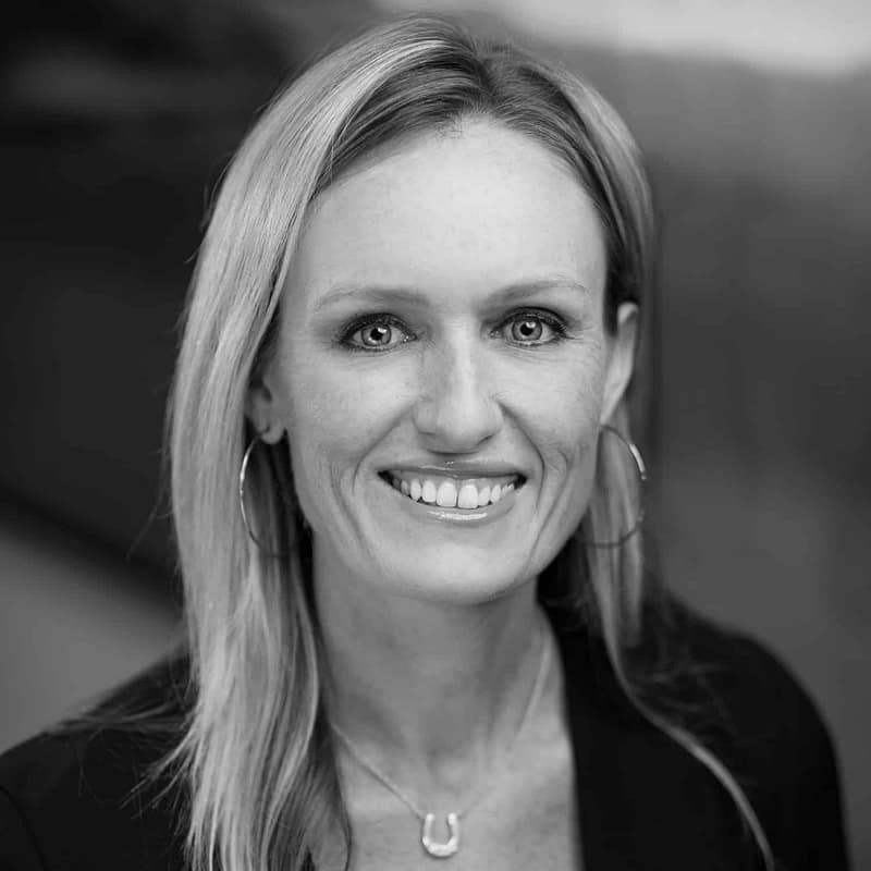 Kelli Carper's headshot in black and white in office space.