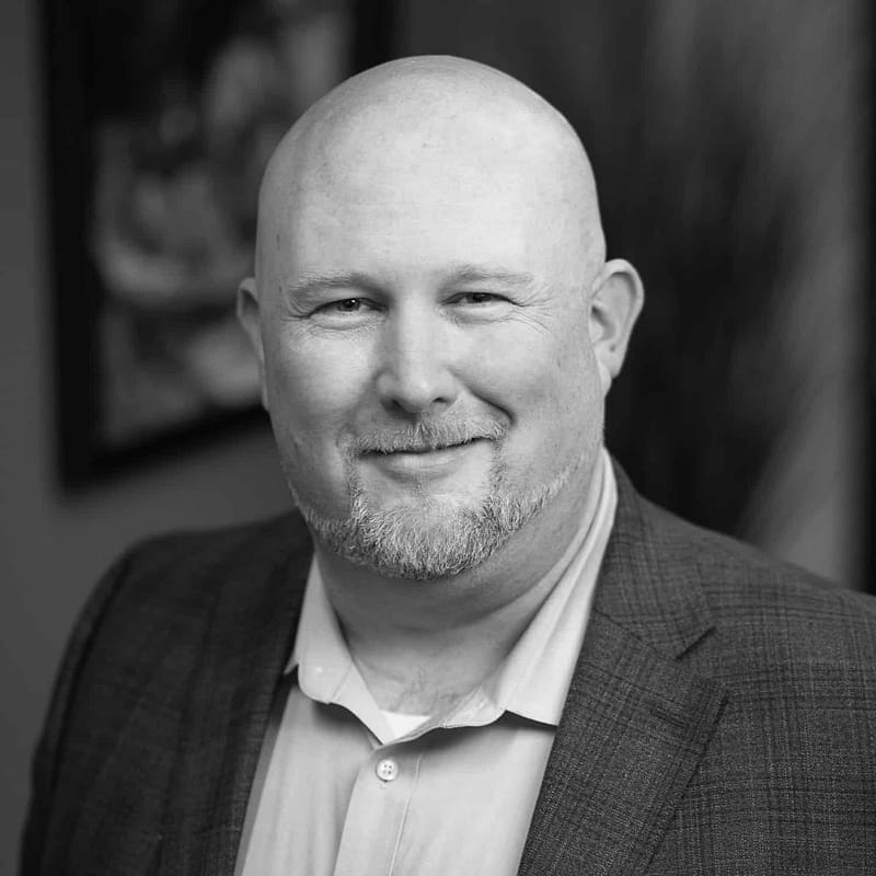 Dave Harris's headshot in black and white in office space.