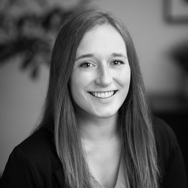 Tiffani Williams' headshot in black and white in office space.