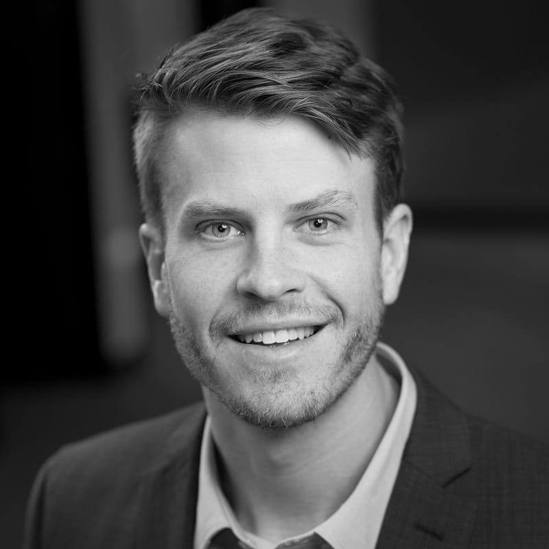 Lucas Zettle's headshot in black and white in office space.