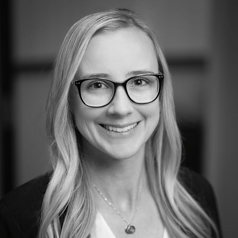 Holly O'Malley's headshot in black and white in office space.