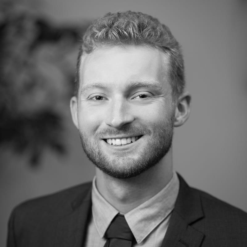 Jackson Davis's headshot in black and white in office space.