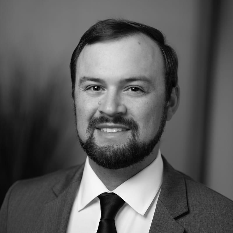 Miles Lewis's headshot in black and white.