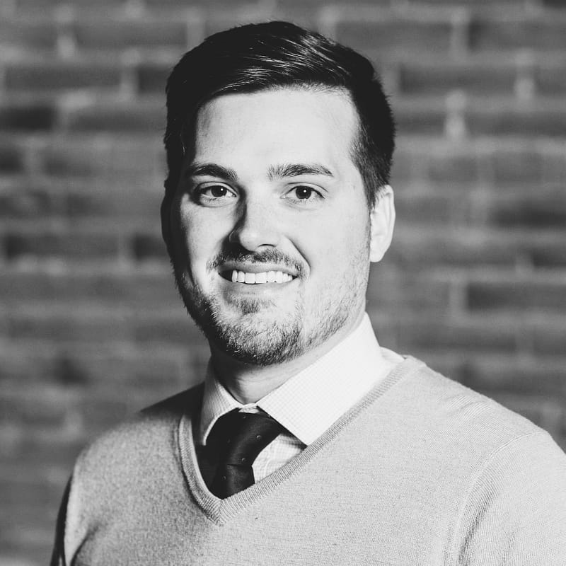 Brady Johnson's headshot in black and white in front of a brick wall.