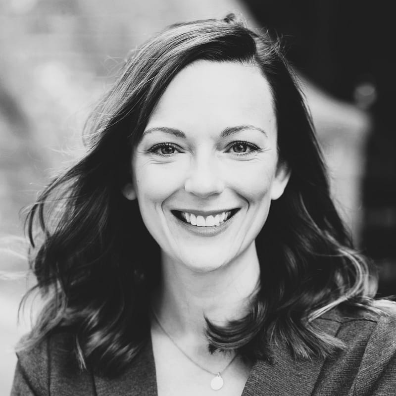 Kristi Bushnell's headshot in black and white outdoors.