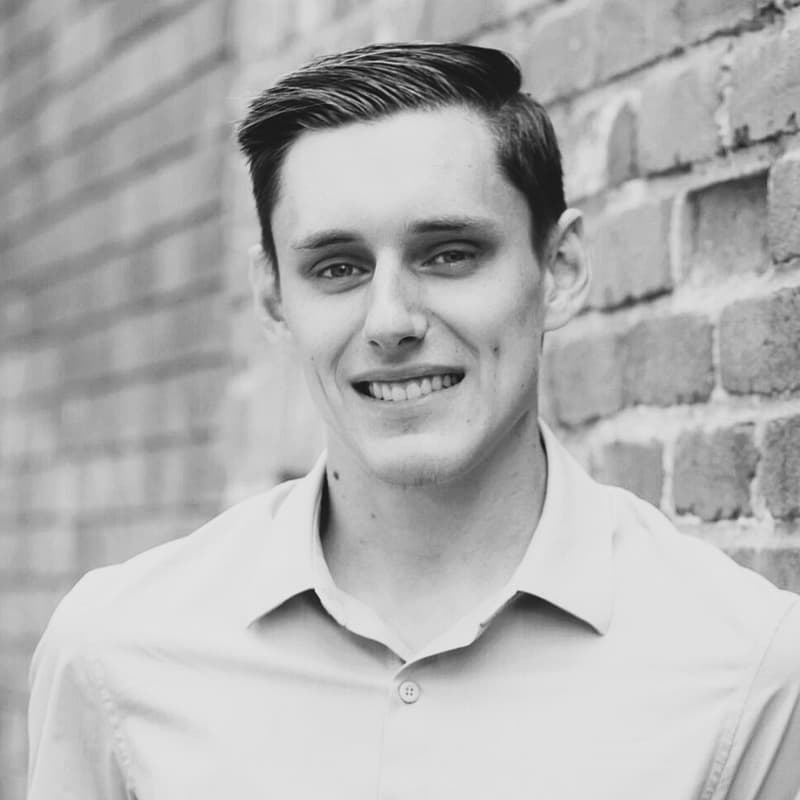 Philip Sigitov headshot, outdoor setting, black and white