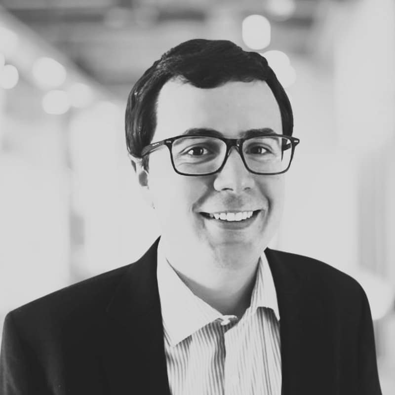 Spencer Janke's headshot in black and white in office space.