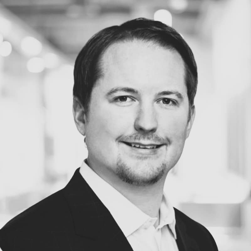 Tim Porter's headshot in black and white in office space.