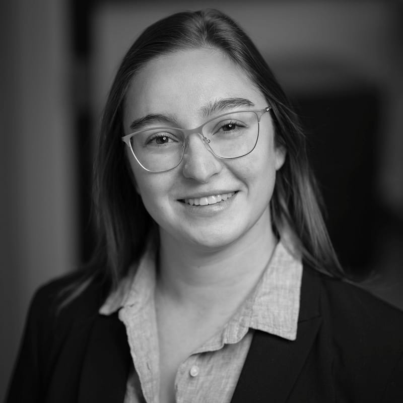 Meridian Ganz-Ratzat's headshot in black and white in office space.