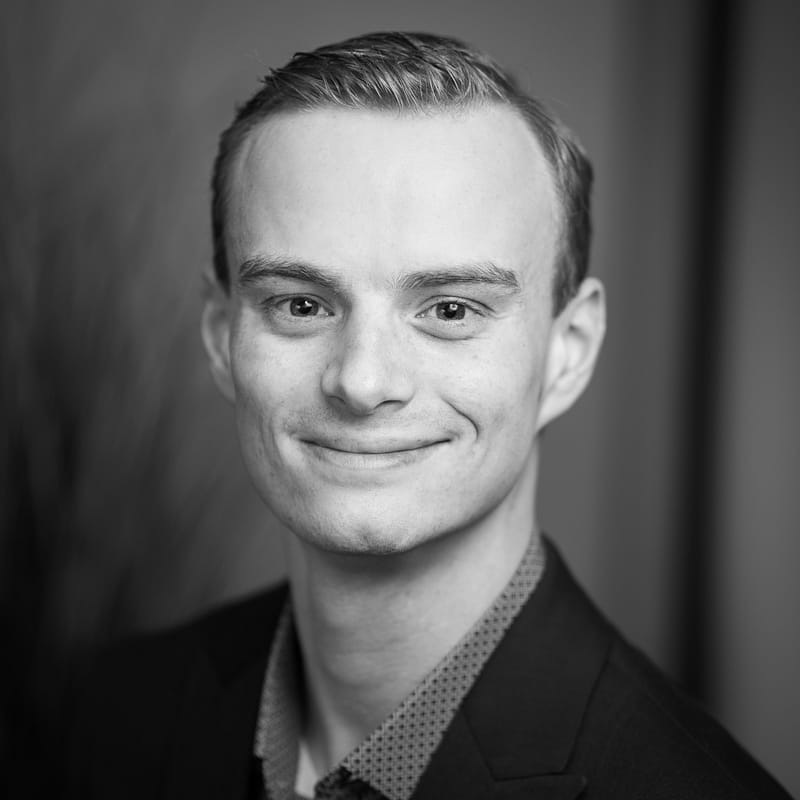 Joe Gittin's headshot in black and white in office space.